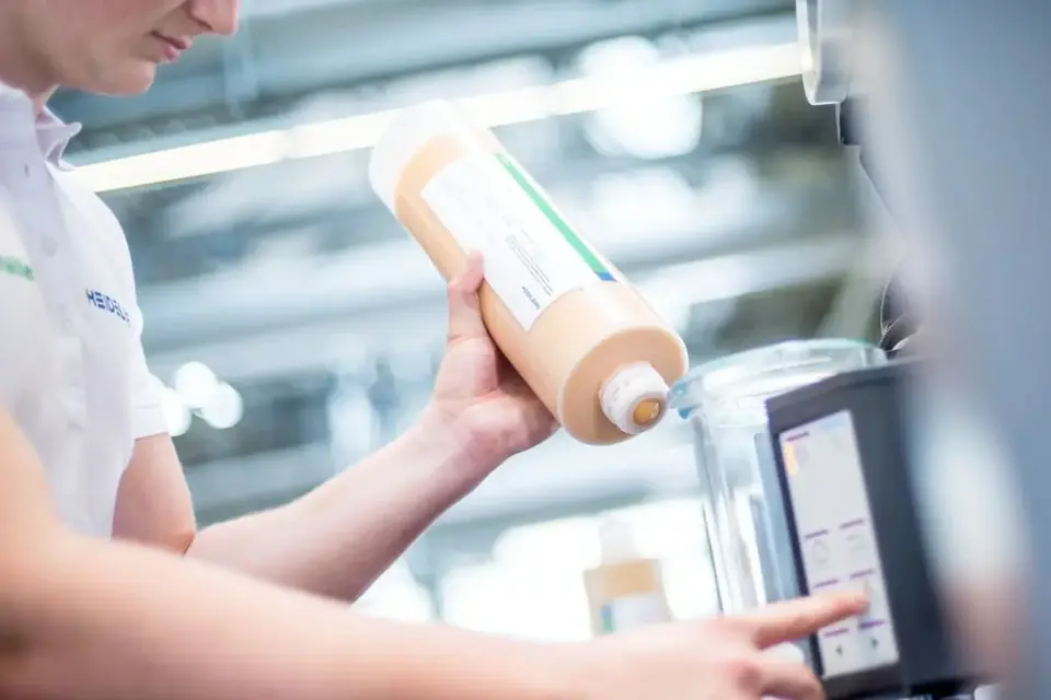 Technician handling ink and pressroom chemistry