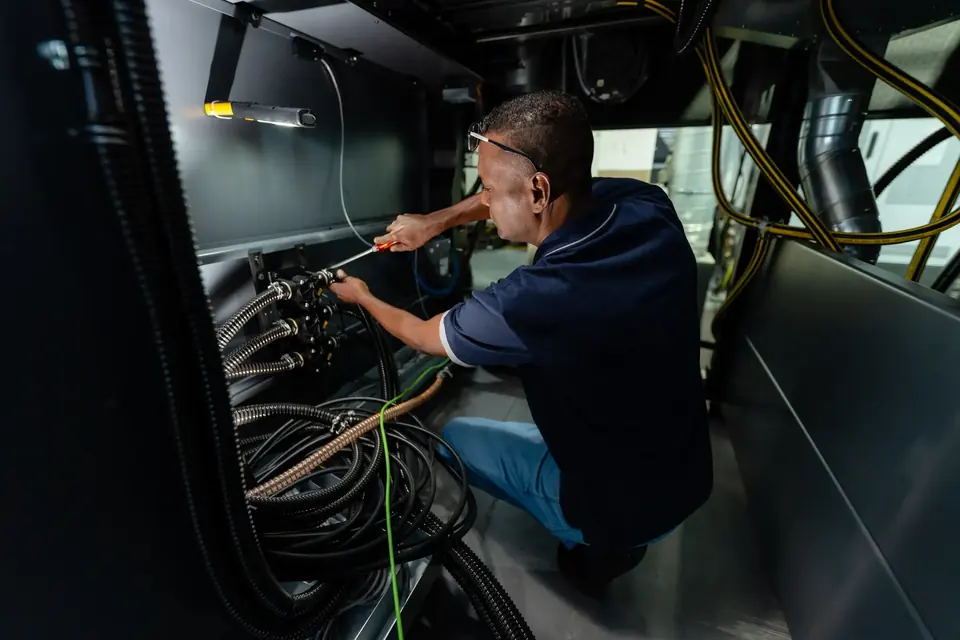 Technician working inside a press